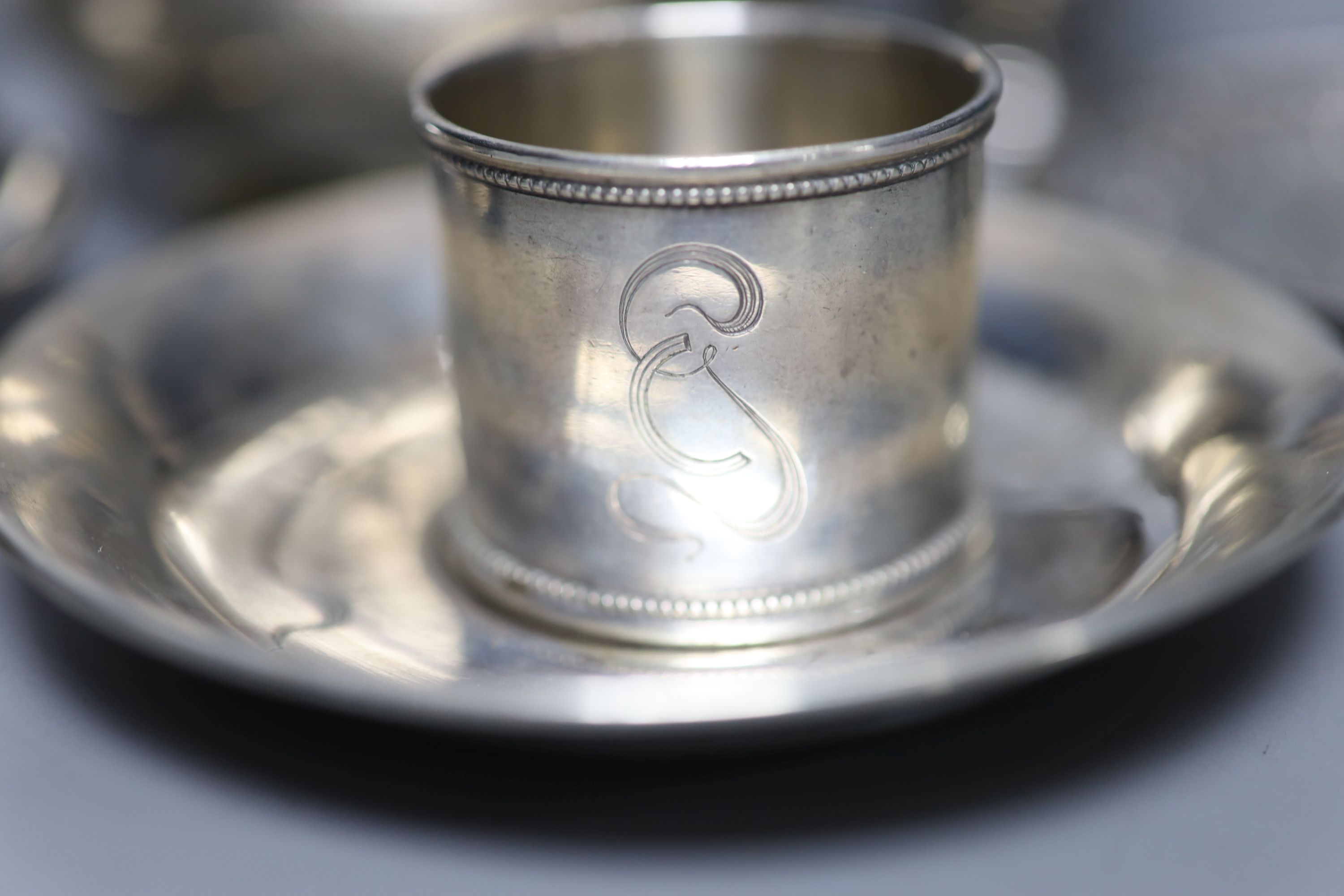 Two early 20th century Russian 84 zolotnik cups and saucers, one other saucer, napkin ring and sugar bowl
